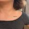 'Believe' temporary tattoo on the shoulder of person in striped shirt