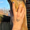 Hand with 'Never give up' temporary tattoo, blurred outdoor background
