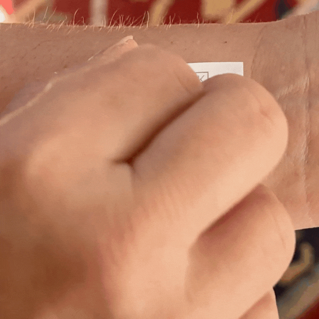 Demonstrating 'Unstoppable' temporary tattoo – powerful black ink word for resilience and drive