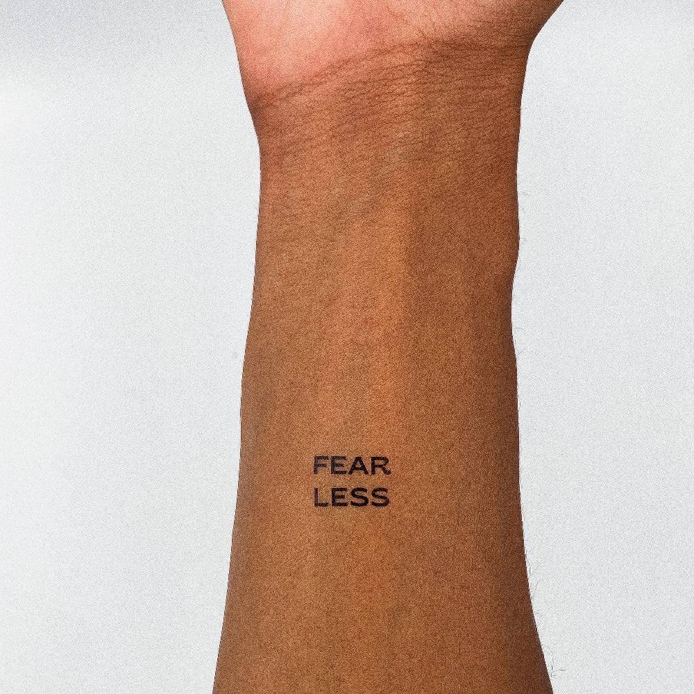 FEAR LESS motivational temporary tattoo on inner forearm, empowering and inspiring mantra tattoo.