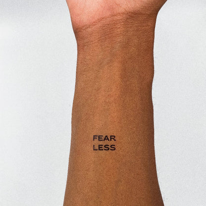 FEAR LESS motivational temporary tattoo on inner forearm, empowering and inspiring mantra tattoo.