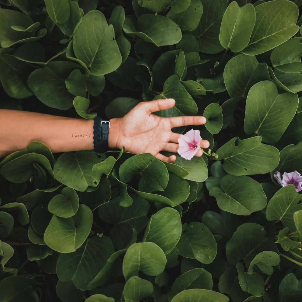 'I can & I will' temporary tattoo on forearm – thin black type motivational quote by Motivink with floral nature background