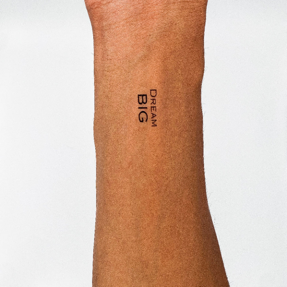 'Dream BIG' inspirational tattoo placed on forearm – temporary black ink quote for vision and ambition