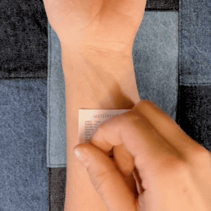 Applying Just Breathe calming mantra manifestation temporary tattoo