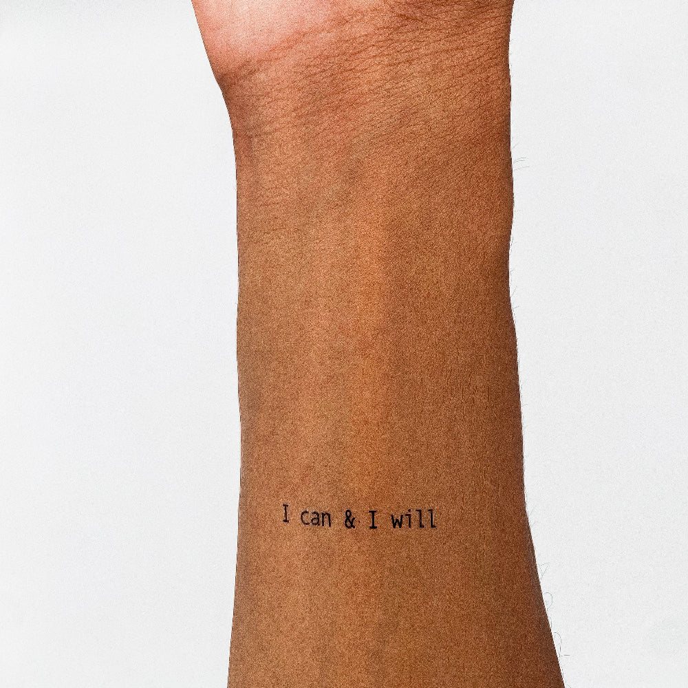 'I can & I will' empowering temporary tattoo on inner forearm, plain white background.