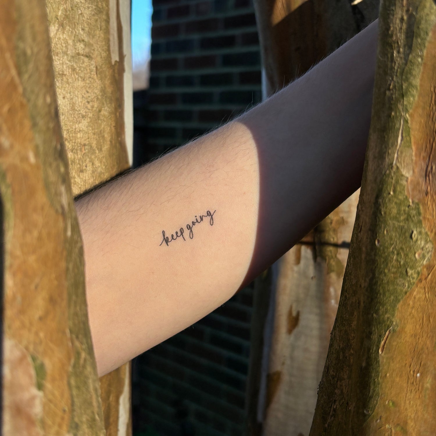 keep going tattoo on arm