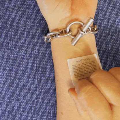 Applying 'Level Up' motivational wrist tattoo – empowering quote for goal setting and growth