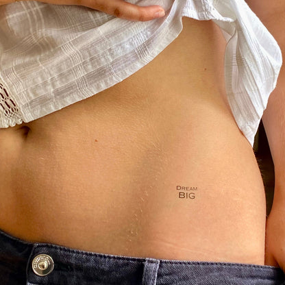 Dream BIG motivational temporary tattoo for visions and dreams placed on waist, minimalist design by Motivink.