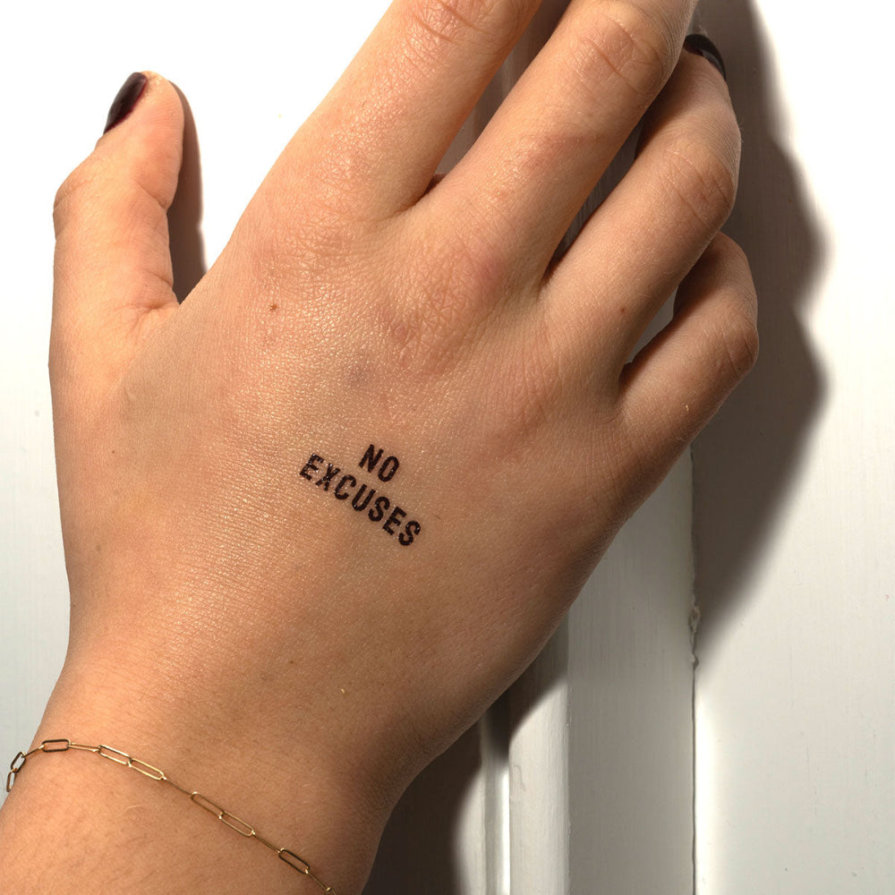 No Excuses bold ink motivational temporary tattoo on back of hand, empowering tattoo by Motivink.